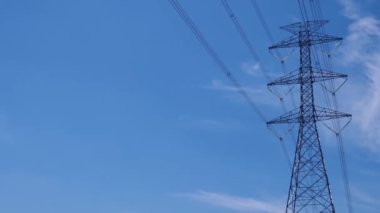 High voltage transmission towers with complex steel structures.