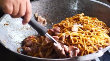 Tayland sokak yiyeceği Kızarmış domuz etli sarı erişte.