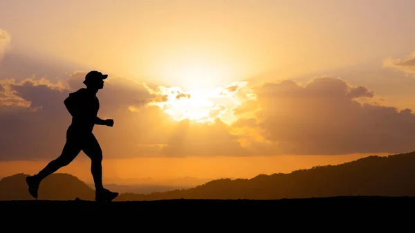 silhouette of a person running at sunset