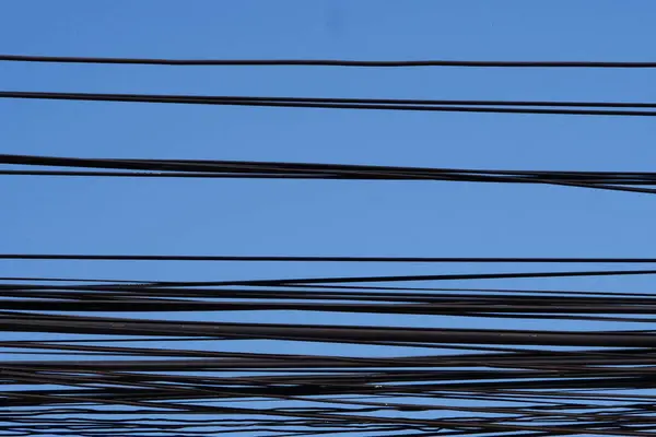 wires of a electric power lines against the blue sky