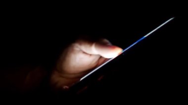 Cep telefonu kullanan bir adam. Adamın eli cep telefonundan bilgi arıyor
