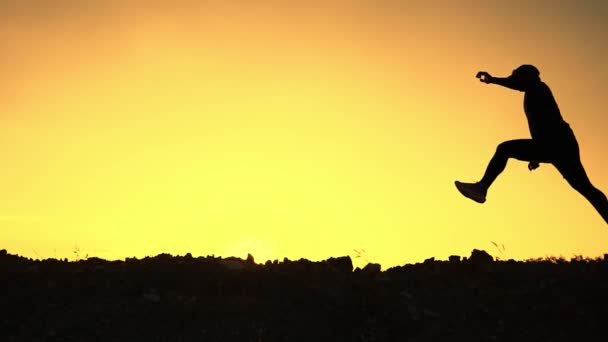 Silhouette of a man happily jogging in the evening. Concept of exercising makes you healthy.