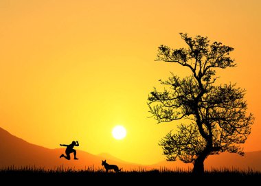 Güzel turuncu gün batımında ağaçların yanında zıplayan insan silueti. 