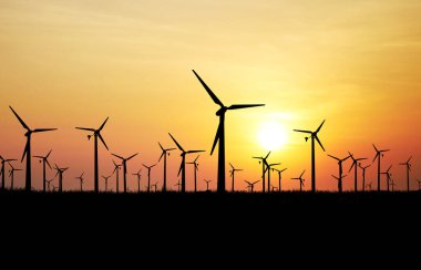 Turuncu gökyüzü arka planında rüzgar türbinleri, eko enerji kavramı