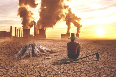 Arka planda endüstriyel bacalar olan kuru çatlamış bir dünyada oturan adam çevresel kirliliği, iklim değişikliğini ve ormansızlaşmayı simgeliyor..