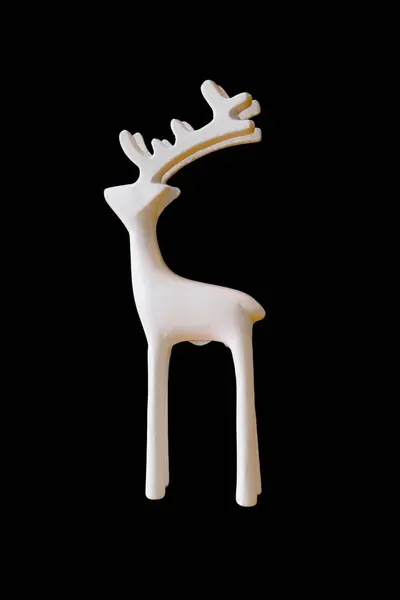 stock image Elegant white ceramic deer sculpture with minimalist design, perfect for modern home decor and art collections. Isolated on a black background.