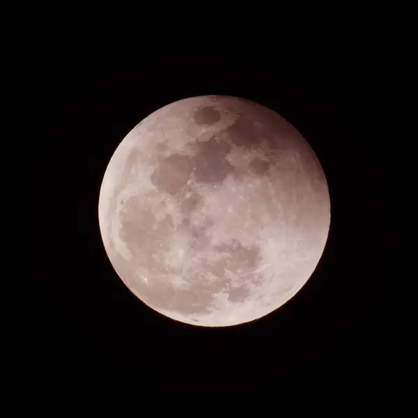 stock image High-resolution image of a full moon against a dark night sky, showcasing detailed craters and surface features.