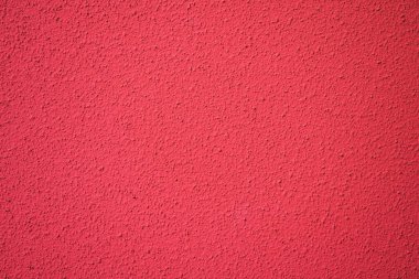 Canlı kırmızı desenli duvarın yakın çekimi, arka plan, tasarım projeleri ve sanatsal ilham için mükemmel..