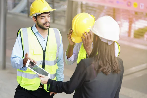 stock image young man engineer is talking work with coworkers at work outside the workplace                               