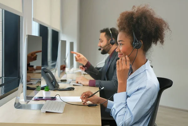 happy african american female wear headsets is working in a call centre, business people operator agents answering phone online