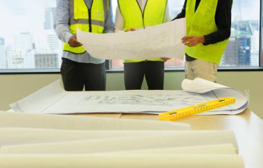 engineering work concept, engineer teams meeting with blue print, selective focus at blue print on table