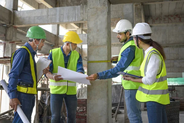construction supervision engineers is measuring concrete pillar the standard of a new building, concept of structural audit,construction supervision