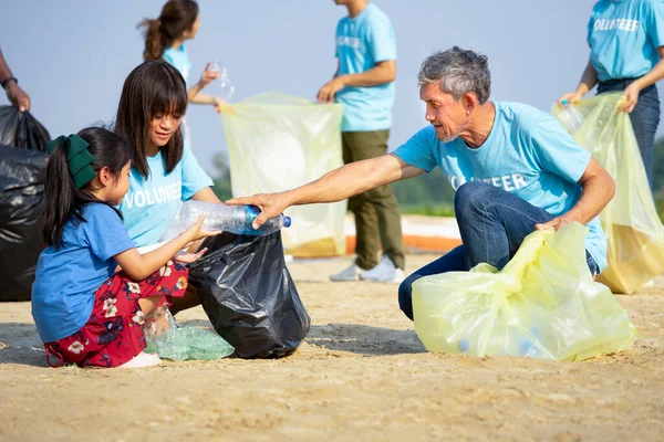 Ομάδα Εθελοντών Καθαρισμού Στην Αμμουδιά Και Ενηλίκων Βοηθούν Παιδιά Συλλέξουν — Φωτογραφία Αρχείου