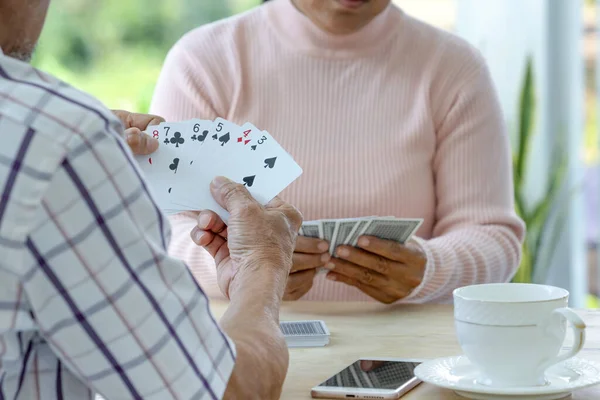senior couple enjoy playing cards game together, concept elderly pensioner lifestyle, entertainment, recreation, encourages social interaction, help memory retention