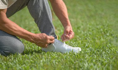 senior man tying shoelace getting ready for exercise, concept of preventing the risk of falls in the elderly