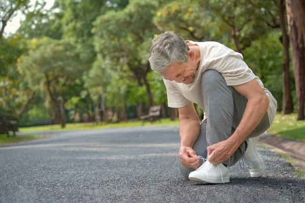Senior Man Tying Shoelace Getting Ready Exercise Concept Preventing Risk Imagen de stock