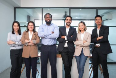 portrait group of multiracial business people standing crossed arms in the office