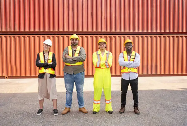 group of diverse container yard workers standing with arms crossed in front of shipping container yard,concept of success of work,pride in work,container in export and import business and logistics