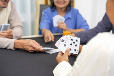group of active senior pensioners playing cards game together, concept elderly retired people entertainment,recreation,encourages social interaction,help memory retention  clipart