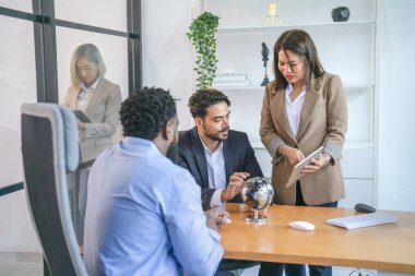 Modern ofis odasında çok ırklı iş ortaklığı tartışması, iş kadını dijital tablet üzerine yeni bir iş projesi hakkında konuşuyor