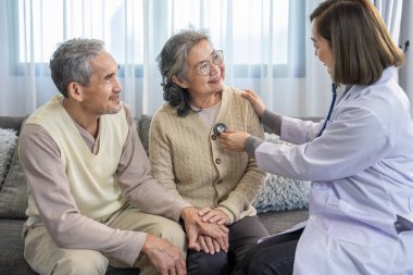 Olumlu duygular, yanında destek veren yaşlı bir kadın, evde genç bir kadın doktordan fiziksel muayene, yaşlanma konsepti, evde bakım, sosyal yardım hizmetleri, evde sağlık hizmetleri...