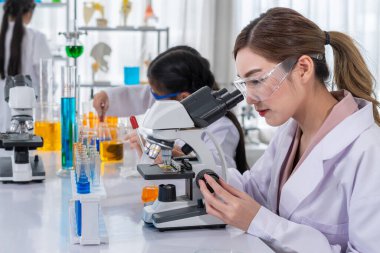 Bir akıl hocası olarak kadın bilim adamı portresi öğrencilere ve laboratuvarda fen eğitimi alan çocuklara öğretiyor.