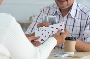 happy senior couple enjoy playing cards game together, concept elderly pensioner lifestyle, entertainment, recreation, encourages social interaction, help memory retention 