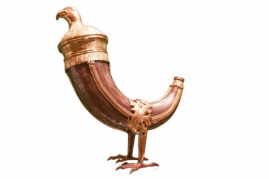 An elaborate vessel resembling a bird stands elegantly, featuring rich brown material with golden accents. The craftsmanship highlights artistic skills from a bygone era.