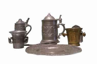 A collection of beautifully crafted metal drinkware is arranged on a clean surface.