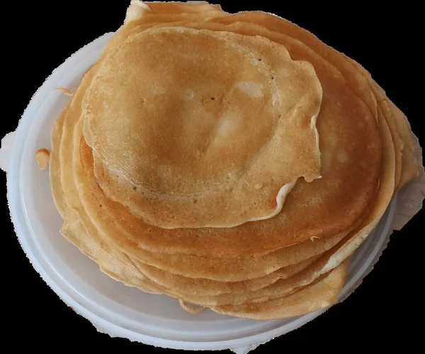 Blush pancakes on a white plate without a background