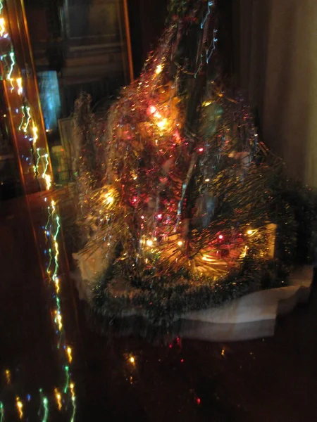 A small Christmas tree with lights and decorations