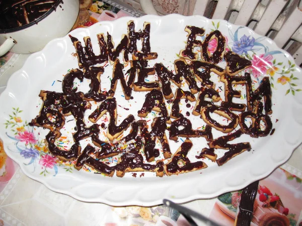 Cookies with chocolate glaze - letters on a plate