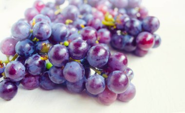 Dark blue grape isolated on white background. Pile of fresh ripe grapes.