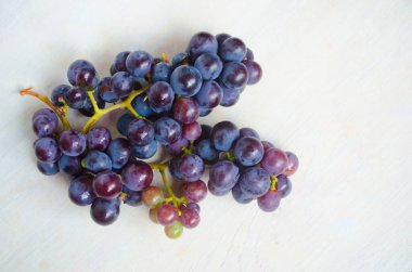 Dark blue grape isolated on white background. Pile of fresh ripe grapes.
