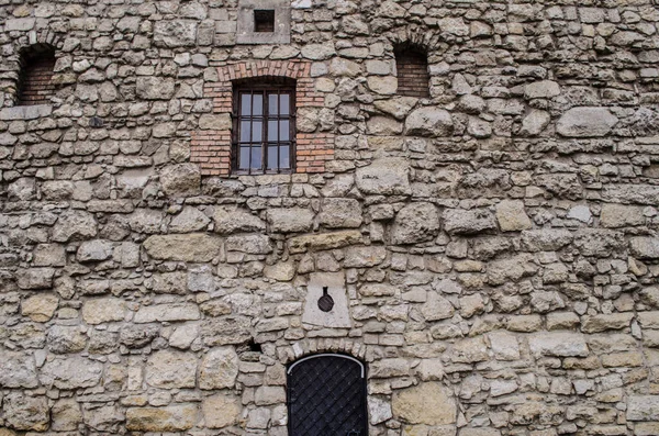 Old stone wall with doors and windows of the Powder Tower in the center of Lviv. Old texture in the center of a European city.
