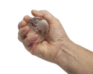 Bir erkek eli, şeffaf bir zemin üzerinde cam toprak küreyi elinde tutar.