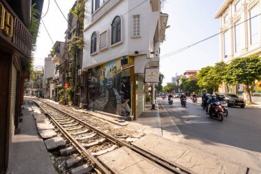 Hanoi, Vietnam, January 2023.  the passage of a train along the tracks between the houses of the old district of the city centre