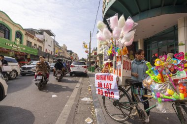 Hanoi, Vietnam, January 2023. the seller of sweets and cotton candy on a street in the city centre