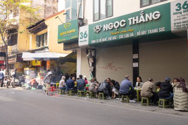 Hanoi, Vietnam, January 2023. a traditional open air sidewalk restaurant in the city centre