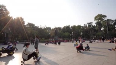 Hanoi, Vietnam. January 2023. children playing with electric vehicles in a square in the city center