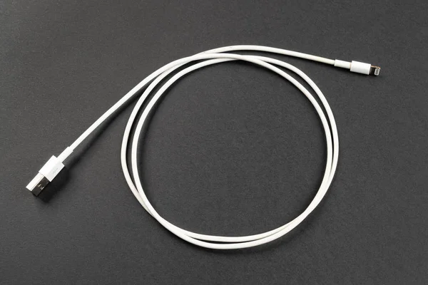 a white USB cable on a gray background