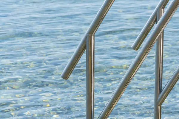 stock image Opatija, Croatia. July 10, 2023. the steel handrail that descends into the sea