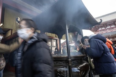 Tokyo, Japonya. Ocak 2024. Şehir merkezindeki Senso ji Tapınağı 'nın önündeki tütsü ocağına sadık..