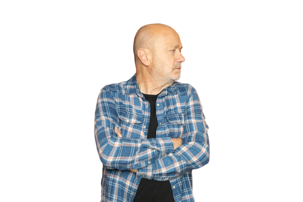 Kolları kalçasında saydam bir arka planda sağa bakan bir adam.