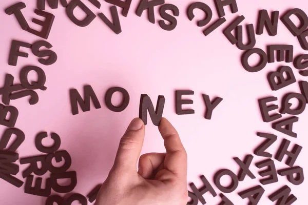 Mans Hand Holds Letter Collects Word Money Letters Light Pink — Stock Photo, Image
