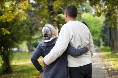 Kucaklayan yaşlı bir çift güneşli bir günde sonbahar parkında yürür, bir adam sevgili karısına ve karısına sarılır, insanlar birlikte zaman geçirir, aşkla uyumlu bir ilişki kurarlar..