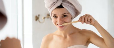 Genç bir kız banyoda dinlendikten sonra dişlerini aynanın yanında fırçalar, kadın havluya sarılır ve vücudunun ve dişlerinin sağlığıyla ve güzelliğiyle ilgilenir..