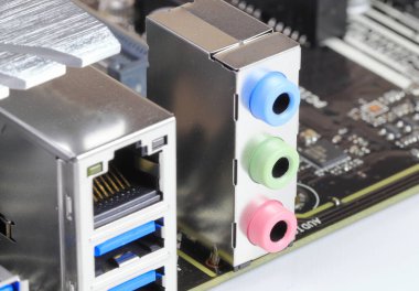 Multiple ports on modern computer mainboard show with USB 3.1, LAN, audio ports.