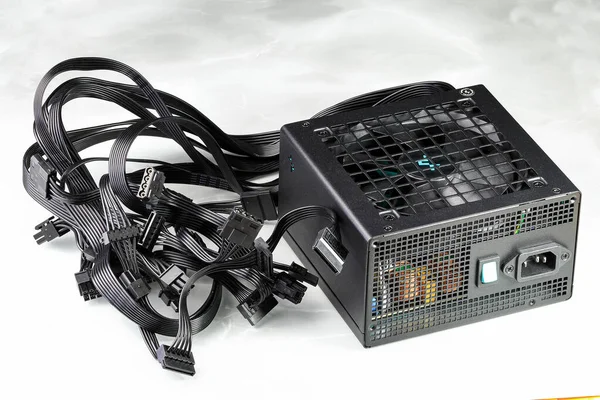 Modern power supply unit, PSU for PC computer or workstation isolated on reflection surface.