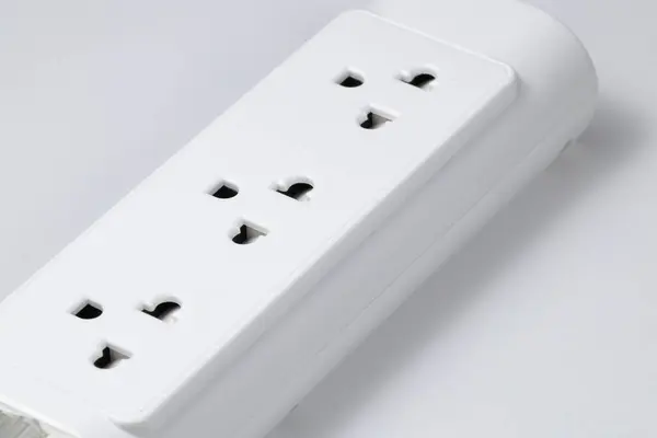 Closeup of electrical power strip or extension block on white background.
